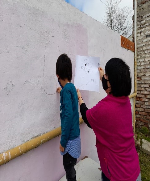 Estudiante pintando el mural
